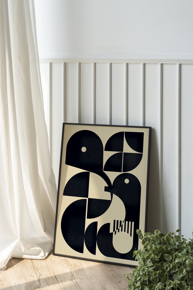 May include: A black and white geometric abstract art print in a black frame. The print features a design of overlapping circles and semi-circles on a cream background.