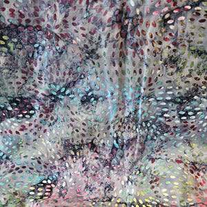 May include: Textile with a gray background and a pattern of colorful, oval-shaped dots. The dots are in shades of red, blue, green, yellow, and pink. The fabric has a textured appearance and a marbled effect.