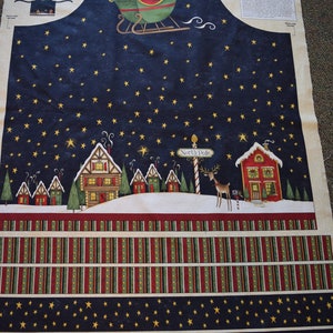 May include: Christmas-themed fabric panel featuring Santa Claus in a sleigh, a starry night sky, and a North Pole scene with houses and a reindeer. The panel includes the text "Santa's Big Night".