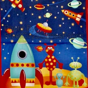 May include: A colorful fabric panel featuring a space theme. The design includes rockets, planets, and cartoon aliens against a starry blue background. Robots are at the top and bottom of the panel.