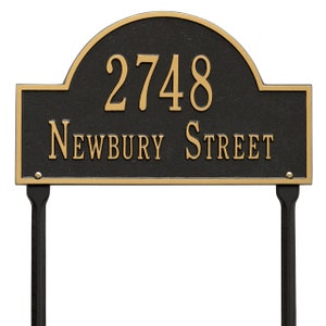 May include: Black and gold metal house number sign with the number 2748 and the street name Newbury Street. The sign is mounted on two black metal stakes.