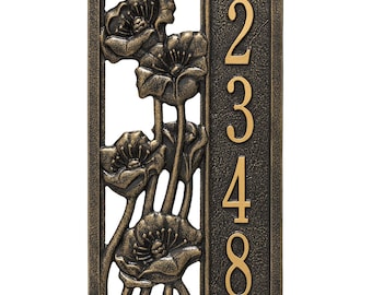 May include: Bronze-colored address plaque featuring a floral design with poppy flowers. The plaque has the numbers 2348 in a gold color. The plaque is rectangular with a decorative border.