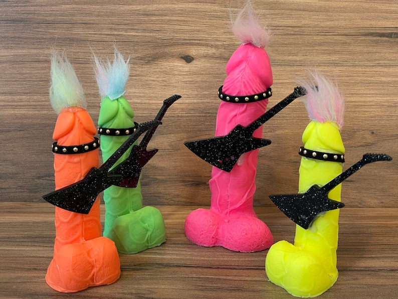 May include: Four colourful figurines with black glitter guitars. Each figurine has a different colour and a black studded belt around the waist.