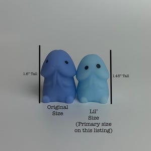 Puede incluir: Dos peque&ntilde;as y caprichosas figuras con forma f&aacute;lica. Una es de color azul claro y la otra es de un azul m&aacute;s oscuro. La figura azul oscuro mide 4,06 cm de alto y la figura azul claro mide 3,68 cm de alto. El texto indica los tama&ntilde;os "Original Size" y "Lil' Size".