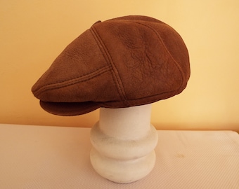 Vintage brown natural lambskin hat with peak. Size L