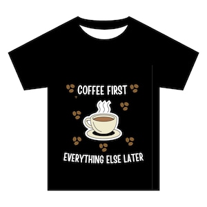 May include: A black short-sleeve t-shirt featuring a central graphic of a steaming cup of coffee on a saucer, surrounded by scattered coffee beans. The text COFFEE FIRST is printed above the cup, and EVERYTHING ELSE LATER is printed below.