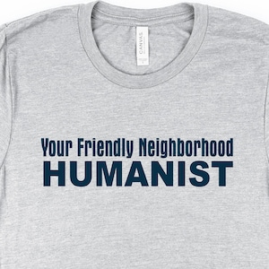May include: A gray t-shirt with the text "Your Friendly Neighborhood HUMANIST" printed in dark blue.
