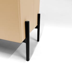 May include: Close-up of a beige cabinet with black legs. The cabinet has a smooth, neutral-toned surface. The black legs are cylindrical and provide a modern contrast to the cabinet's color.