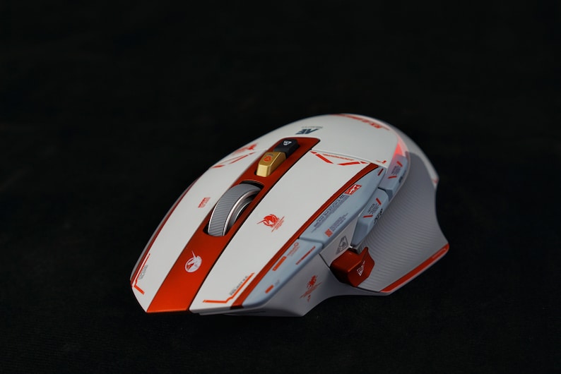 May include: A white and red gaming mouse with a scroll wheel and multiple buttons. The mouse has a textured surface and a red accent stripe.