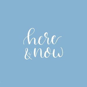 May include: White text on a light blue background reads "here & now".