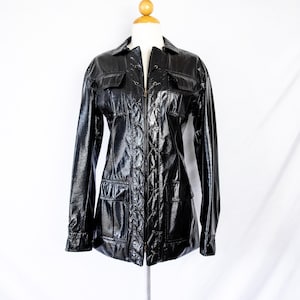 May include: A black, shiny, zippered jacket with a lace-up front and multiple pockets.