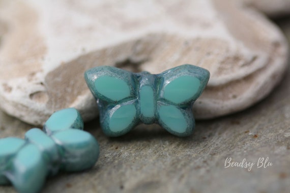 Two 20x12mm Butterfly Czech glass beads in half AB Finish and other side blue translucent