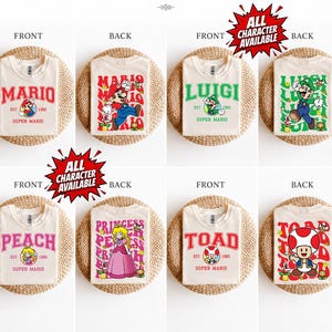 May include: A selection of cream-coloured t-shirts featuring Super Mario characters. Each shirt displays a character's name in bold letters, with matching character graphics. The front and back designs include Mario, Luigi, Peach, and Toad. The text "ALL CHARACTER AVAILABLE" is also visible.