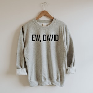May include: A gray sweatshirt with the text "EW, DAVID" printed in black.