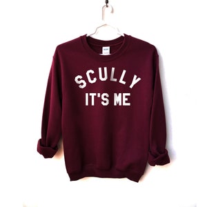 May include: Burgundy sweatshirt with white text that reads "SCULLY IT'S ME"