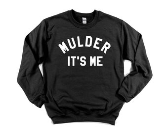 May include: Black sweatshirt with white text that reads "Mulder It's Me" in an arched font.