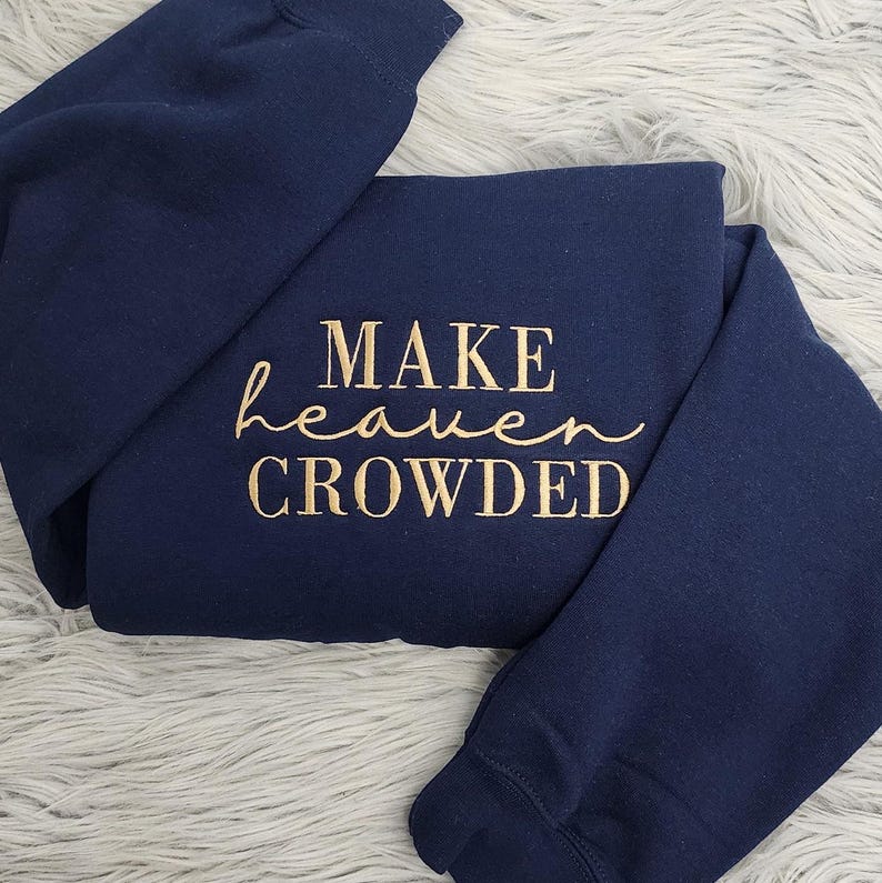 May include: Navy blue sweatshirt with gold lettering that reads "MAKE heaven CROWDED".