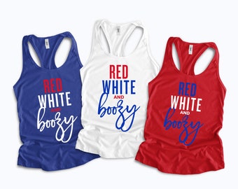 May include: Three tank tops with the text "Red White and Boozy" in red, white, and blue lettering. The tank tops are blue, white, and red.