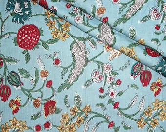 May include: A blue fabric with a floral pattern. The pattern features red, white, and yellow flowers with green leaves.
