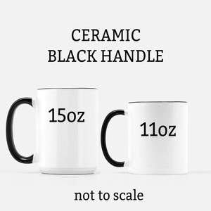May include: Two white ceramic mugs with black handles. The mug on the left is 15 oz and the mug on the right is 11 oz.
