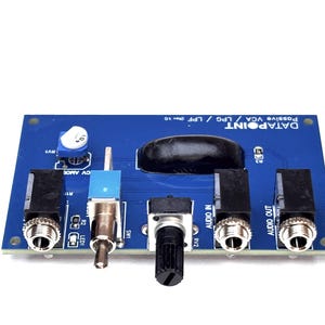 May include: A blue printed circuit board labeled DATAPOINT Passive VCA / LPG / LPF (Rev 1.0) featuring three black audio jacks, a silver toggle switch, a black rotary knob, a blue potentiometer, and a black epoxy-covered component.