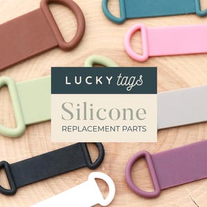 May include: A collection of colorful silicone replacement parts in various shades, including brown, green, pink, gray, black, teal, and purple. The text "LUCKY tags Silicone Replacement Parts" is displayed on a rectangular label.