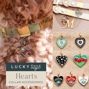 May include: A collection of heart-shaped dog tags with various colorful designs, including flowers, stars, cherries, and an evil eye. The text "LUCKY tags Hearts COLLAR ACCESSORIES" is displayed below the tags.