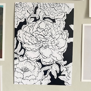 May include: Black and white line art print of peonies on a black background. The peonies are drawn in a detailed and realistic style.