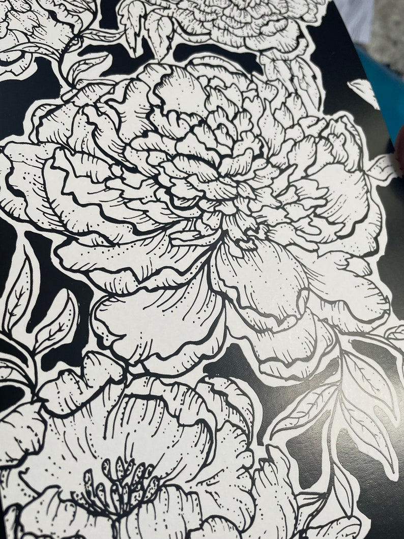 May include: Black and white line art print of a floral pattern featuring peonies. The print features intricate details of the flowers and leaves.