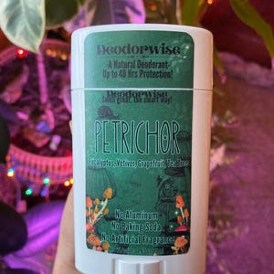 May include: A white deodorant stick with a green label featuring the text "Deodorwise" and "PETRICHOR". The label also lists ingredients and features a mushroom illustration. The product is 2.65 oz.