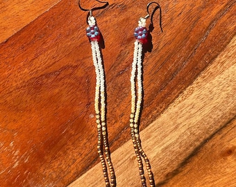 Beaded fringe earrings Native American made with brown, gold, and white beads with a red flower charm.