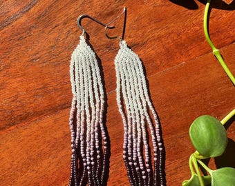 Beaded fringe earrings with purple and white beads. Native American made in Washington State.
