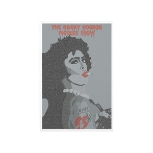 May include: A gray and red poster with the text "THE ROCKY HORROR PICTURE SHOW" at the top. The poster features a close-up of a person with dark hair and a red heart tattoo on their arm.