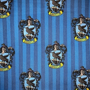 May include: Blue and yellow fabric with a repeating pattern of the Ravenclaw house crest from the Harry Potter series. The crest features a raven and the words "Ravenclaw" on a banner.