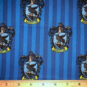 May include: Blue and yellow fabric with a repeating pattern of the Ravenclaw house crest from the Harry Potter series. The crest features a raven, a wizard's hat, and the words "Ravenclaw".
