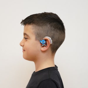Illustrated by acclaimed artists Bionic Ninja Hearing Aid Tube Rider/Charm is exclusive to Little Auricles. You won’t find him anywhere else