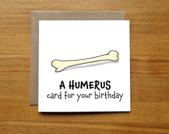 May include: A white card with a cartoon bone and the text "A HUMERUS card for your birthday".