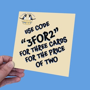 May include: A beige card with black text that reads "Blueberry Magpie Cards" and "Use Code "3FOR2" for three cards for the price of two". The card features a cartoon image of two magpies on a pie.