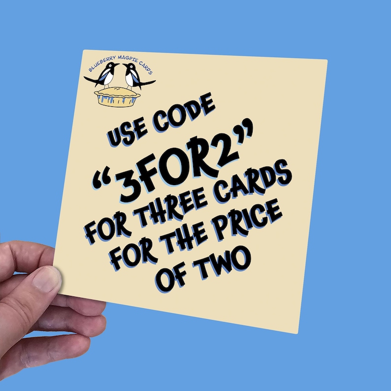 May include: A beige card with black text that reads "Blueberry Magpie Cards" and "Use Code "3FOR2" for three cards for the price of two". The card features a cartoon image of two magpies on a pie.