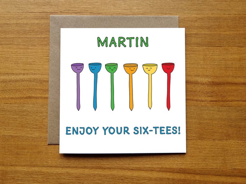 May include: A white card with the name "MARTIN" printed in green letters.  Below the name are six colorful golf tees with smiley faces. The text "ENJOY YOUR SIX-TEES!" is printed in blue letters below the golf tees.