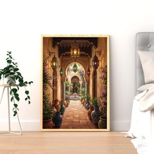 May include: A framed print of a Moorish courtyard scene. The image shows a long, arched corridor with colourful lanterns, potted plants, and decorative vases. The colour scheme includes warm earth tones, greens, and vibrant accents.