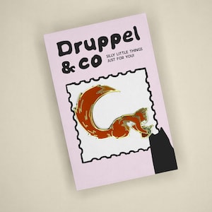 May include: A light pink rectangular backing card featuring the text Druppel & CO SILLY LITTLE THINGS JUST FOR YOU! and a central white stamp-shaped graphic containing a metallic orange squirrel enamel pin with a large bushy tail.