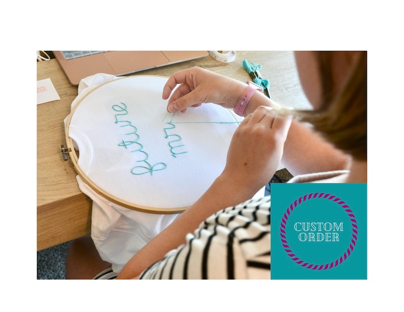 May include: A white t-shirt in an embroidery hoop with the words "future mrs" stitched in teal thread. A person is shown embroidering the shirt. A teal and purple custom order graphic is in the lower right corner.