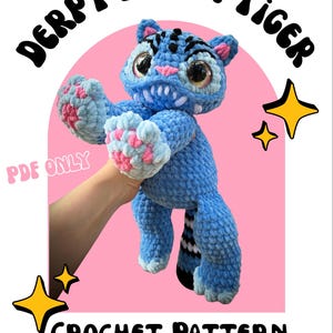 May include: A blue crochet tiger with pink and white details, with large eyes and a toothy grin. The text "DERPY DEMON TIGER" curves above the tiger, with "CROCHET PATTERN" below. The words "PDF ONLY" are also visible.