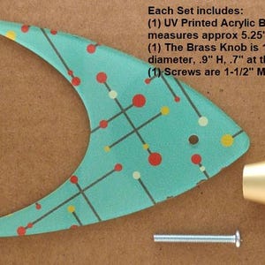 May include: A mid-century modern style furniture hardware set. The set includes a teal acrylic backplate with a colorful dot and line pattern, a brass knob, and a screw. The backplate measures approximately 5.25"W x 4"H.