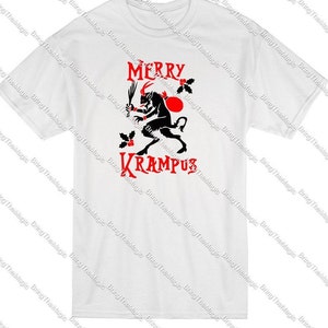May include: White t-shirt with a red and black graphic of a horned creature holding a whip and a sack. The text "Merry Krampus" is printed in red.