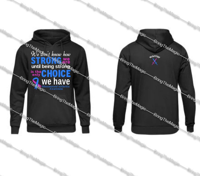 May include: Black hooded sweatshirt with a blue and pink ribbon and the text "We don't know how STRONG we are until being strong is the only CHOICE we have Rheumatoid Arthritis Awareness". The back of the sweatshirt has a pink and blue sword design with the word "warrior".