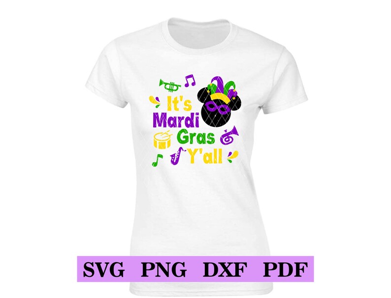 May include: White t-shirt with a purple, green and yellow design. The design features a cartoon mouse head with a jester's hat, musical notes, a trumpet, a drum and a saxophone. The text reads "It's Mardi Gras Y'all".