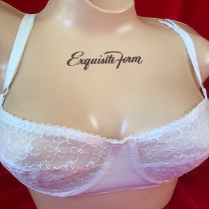 May include: White lace bra with adjustable straps. The bra has a scalloped edge and a delicate floral pattern. The brand name "Exquisite Form" is printed on the bra.