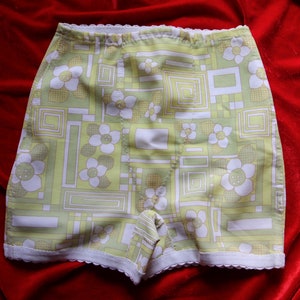 May include: White and green geometric patterned underwear with a white lace trim.